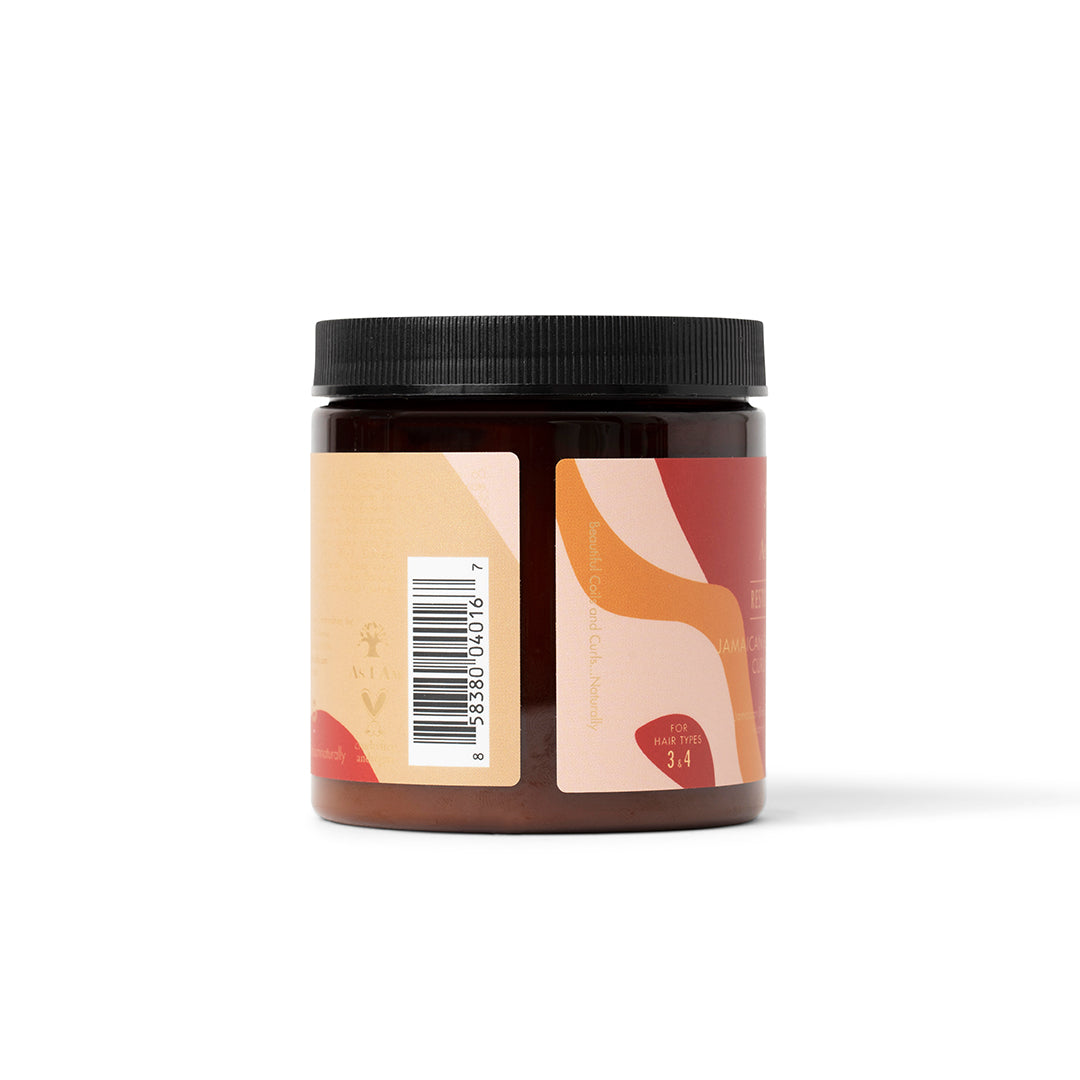 The side of a dark container of As I Am Jamaican Black Castor Oil Curling Creme (227g) with a beige and pink label showing a barcode and some product information.