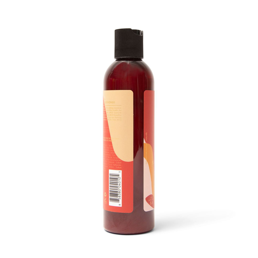 The side of a dark bottle of As I Am Jamaican Black Castor Oil Leave-in Conditioner (237 ml) with a beige and pink label showing a barcode and parts of the product information.