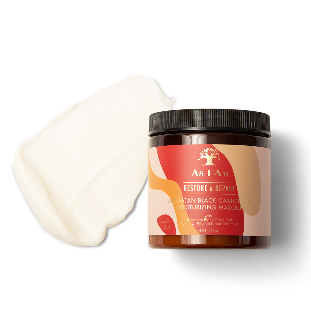 As I Am Jamaican Black Castor Oil Moisturizing Masque (227g) with a dollop of the white, creamy mask next to it. The label is pink and beige and shows the product name and a short description in both English and French.