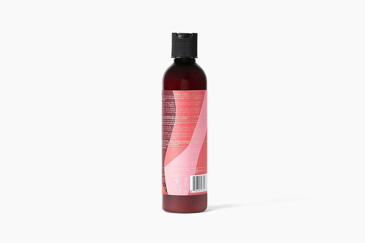 The back of a brown bottle of As I Am Long & Luxe GroYogurt Leave-in Conditioner (237 ml) with a pink label showing ingredients and directions for use.