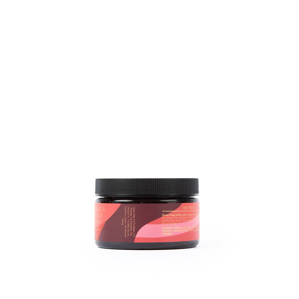 The back of a black jar of As I Am Long & Luxe GroEdges (113g) with a pink label containing the ingredient list and instructions for use.