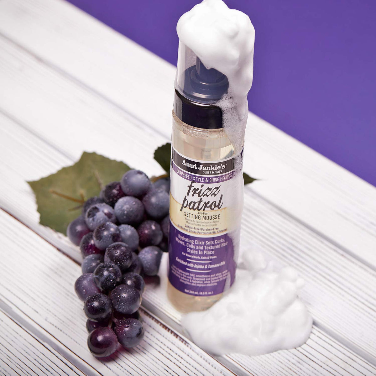 Close-up of Aunt Jackie's Frizz Patrol Mousse, demonstrating the light and airy texture. The mousse is pumped out and ready for use in the hair.