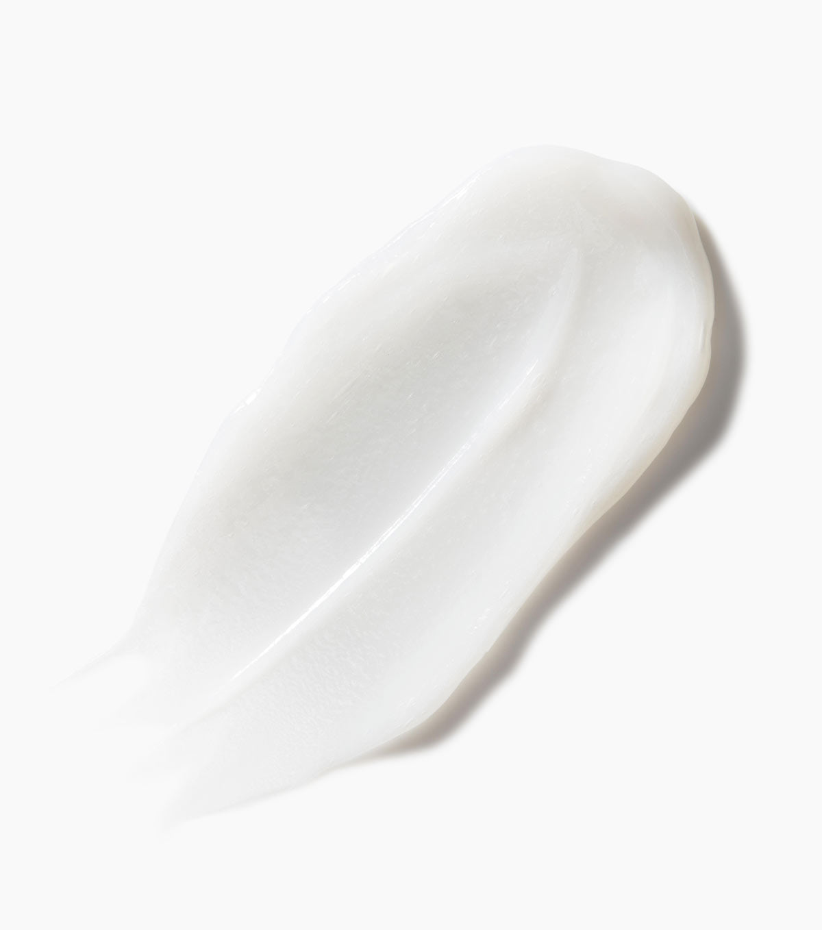 A soft, white blob of cream against a pure white background. The cream is from Not Your Mother's Royal Honey & Kalahari Desert Melon Conditioner.