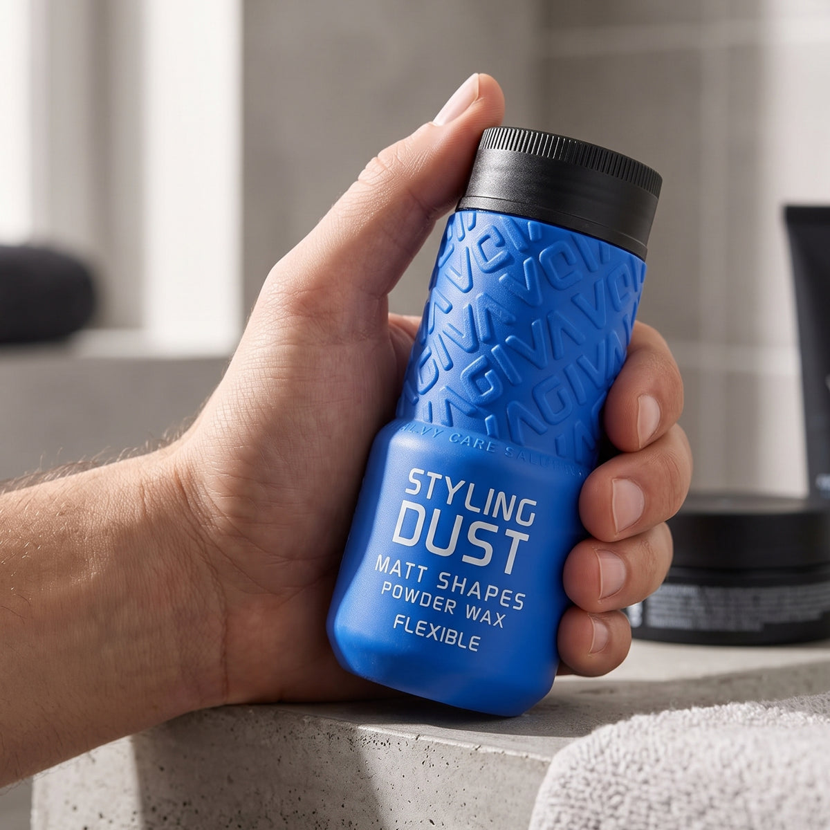 Hand holds blue GIVA Styling Dust bottle with black lid, matting powder wax for flexible styling.