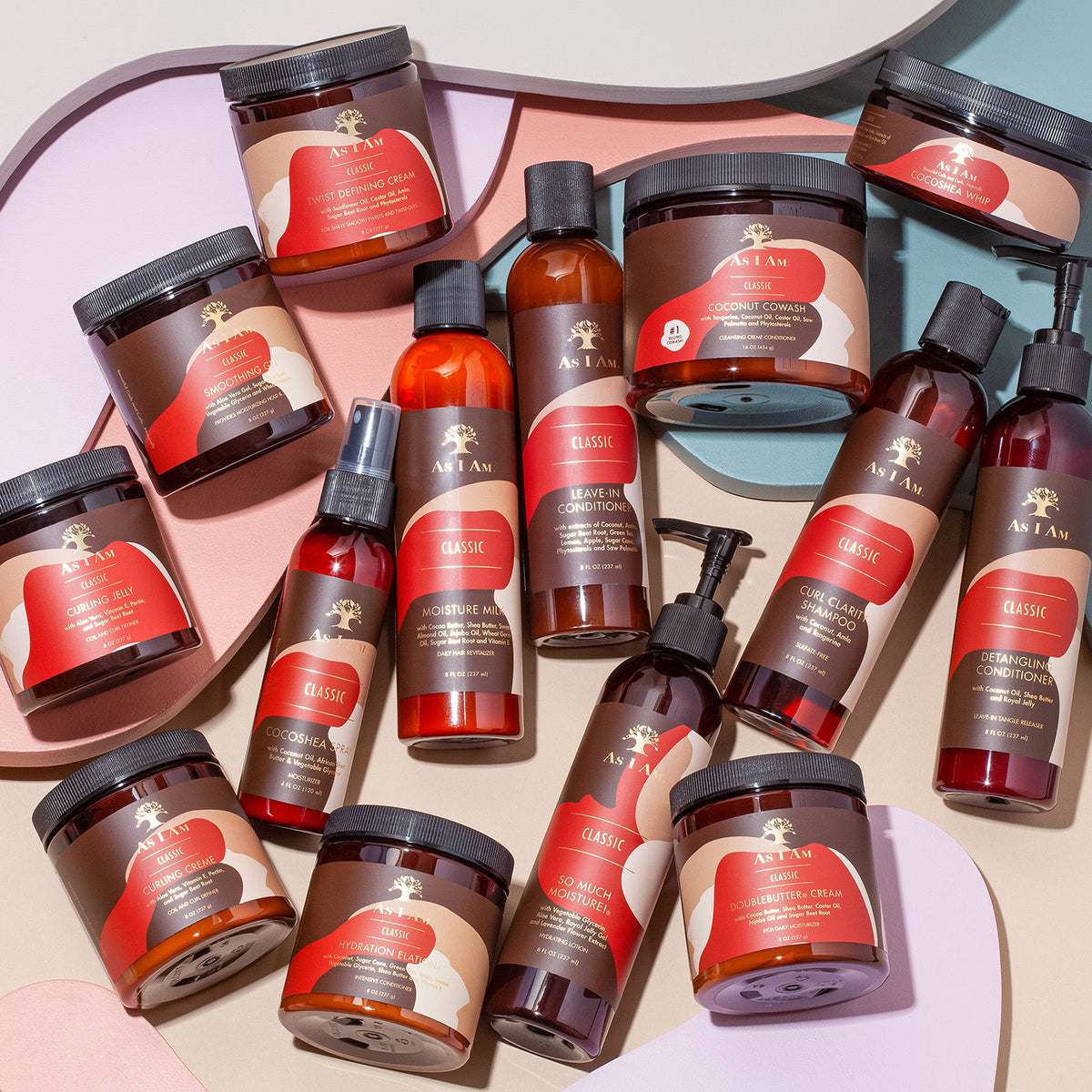As I Am Classic hair care series collected in a flat lay with creams, lotions, shampoos and leave-in products on a colored background.
