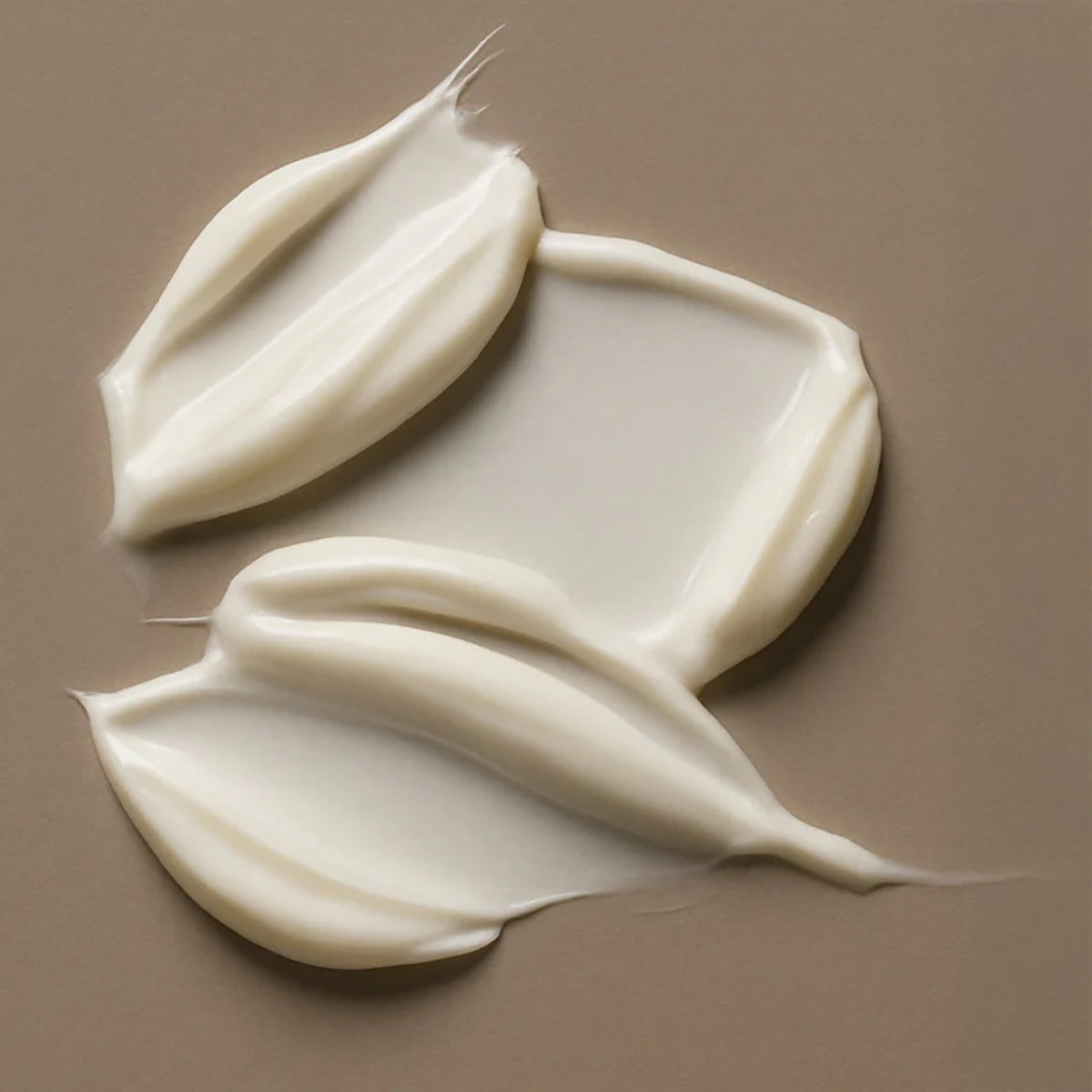 The creamy texture of Bali Gents Matt Paste 100ml spread in soft strokes on a neutral beige background.