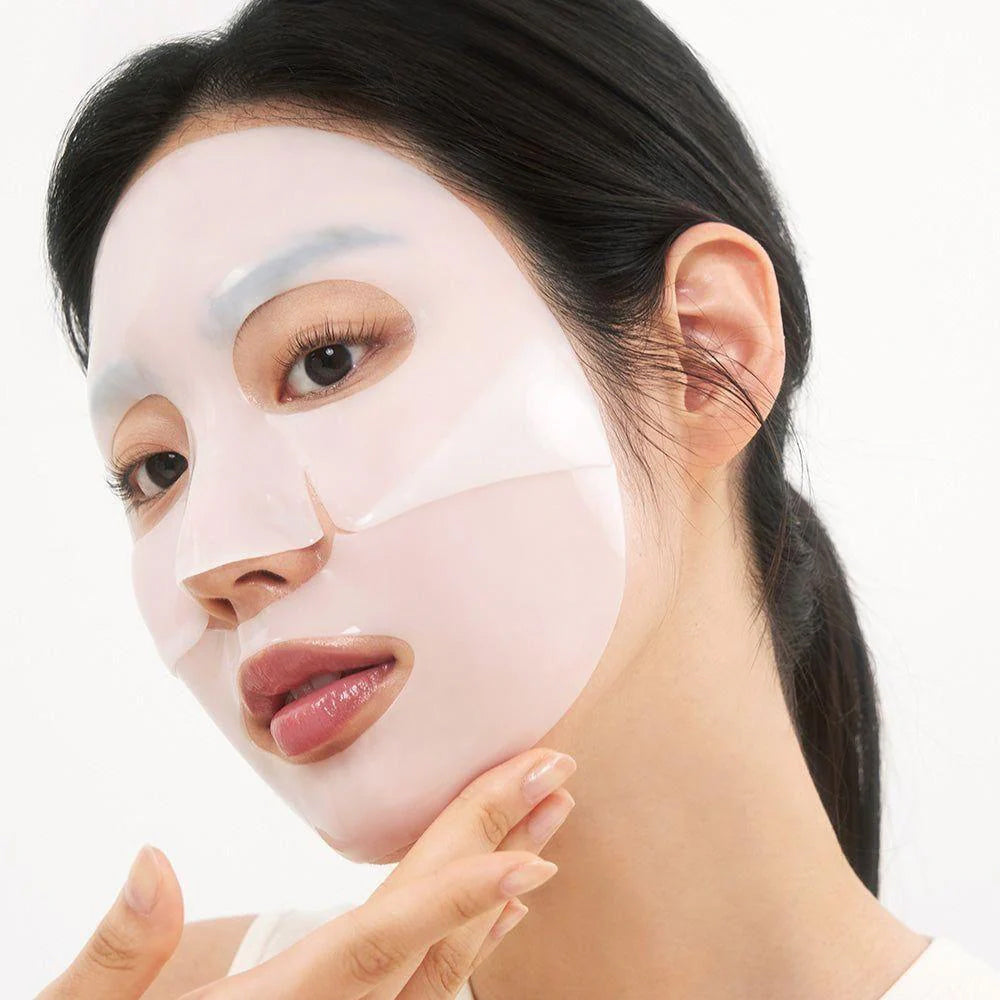 Woman with Biodance Hydro Cera-nol Real Deep Mask on the skin, which provides intensive moisture and glow to the face.