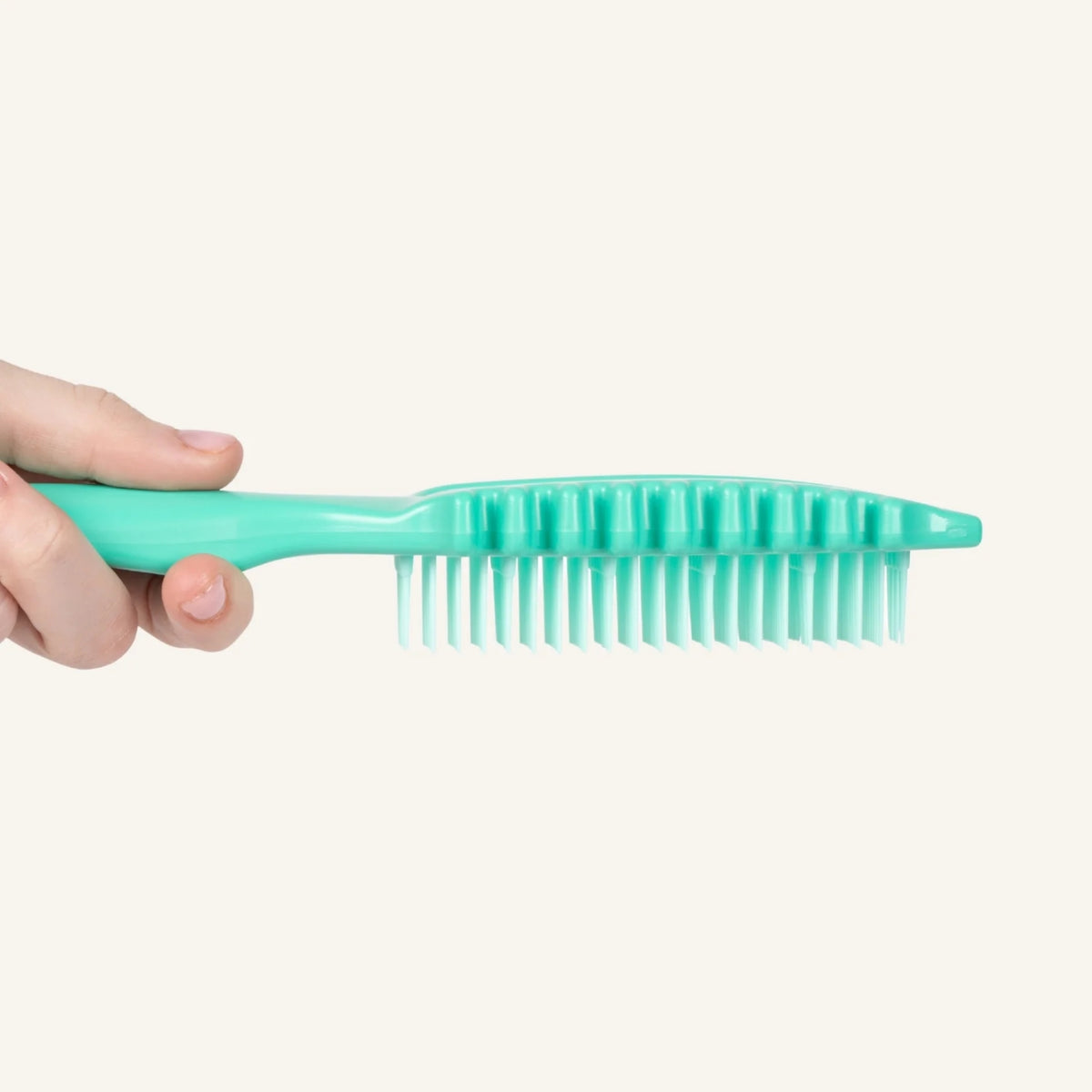 Side profile of the Bounce Curl Slick-Flex Define brush showing the unique side combs and soft bristles for curl definition and hair separation.