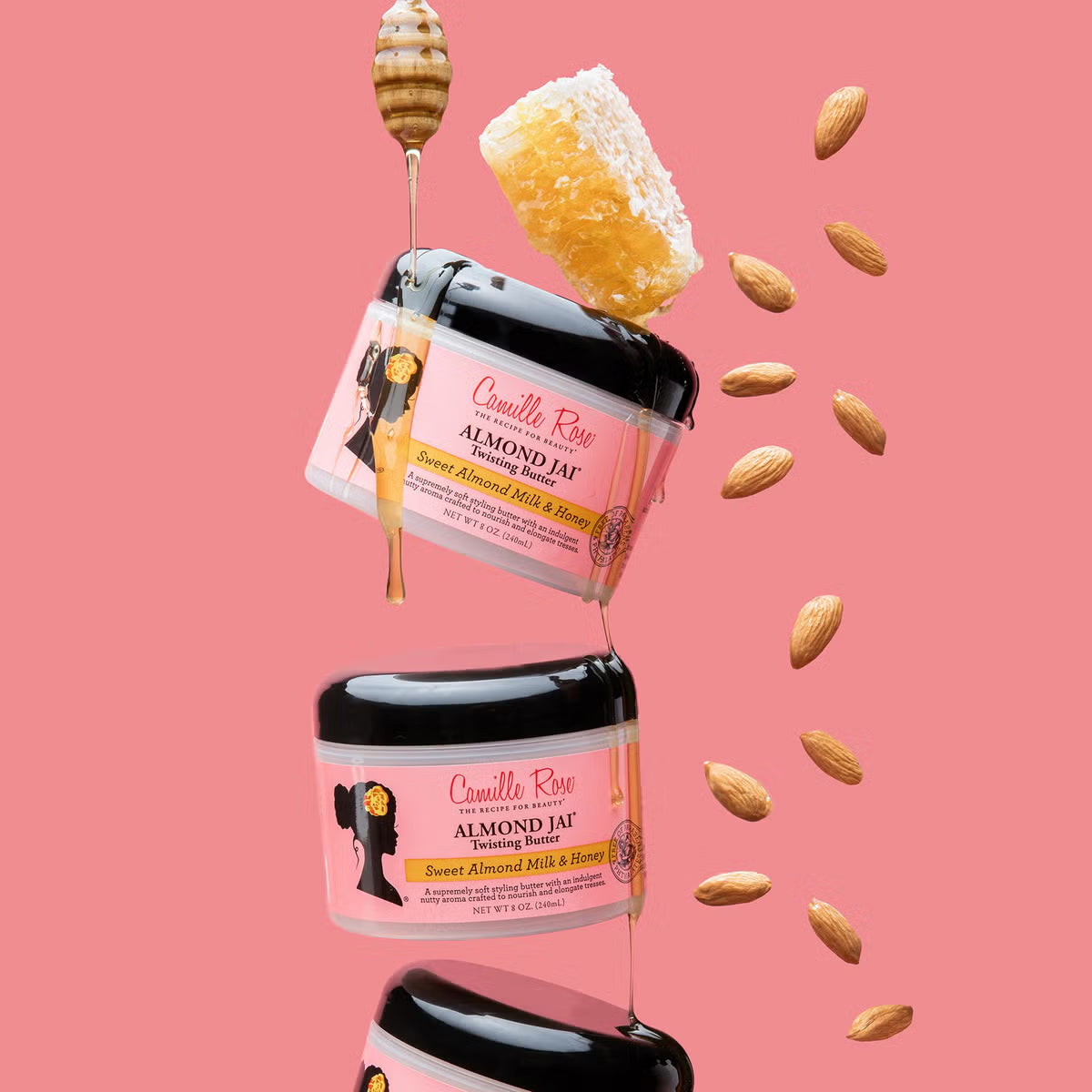 More Camille Rose Almond Jai Twisting Butter on pink background with liquid honey and almonds.

