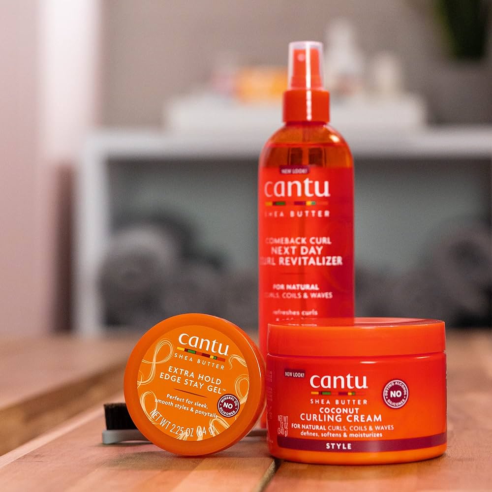 Cantu products for styling and caring for curly hair: edge control, curl revitalizer and curling cream.