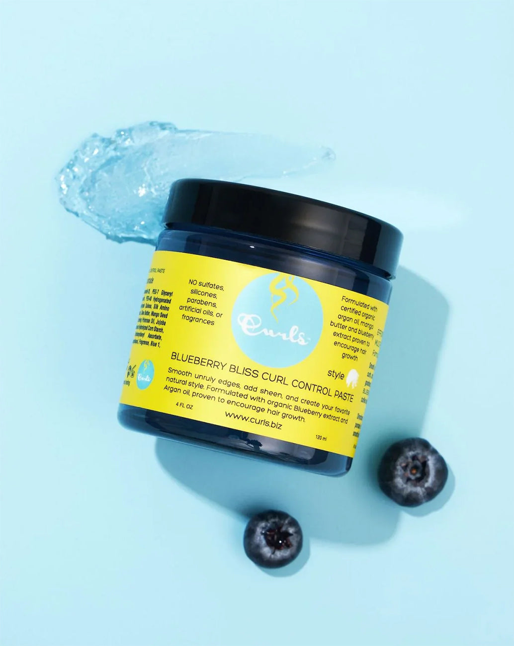 Curls Blueberry Bliss Curl Control Paste: Bluish styling paste with blueberries that shows the consistency of the product.