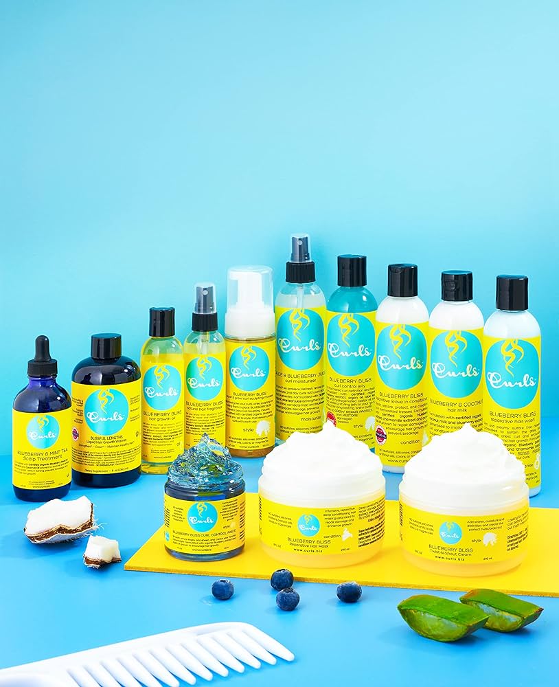Curls Blueberry Bliss products: Hair care series with blueberries, aloe vera and white comb on a blue background. Includes reparative hair products.