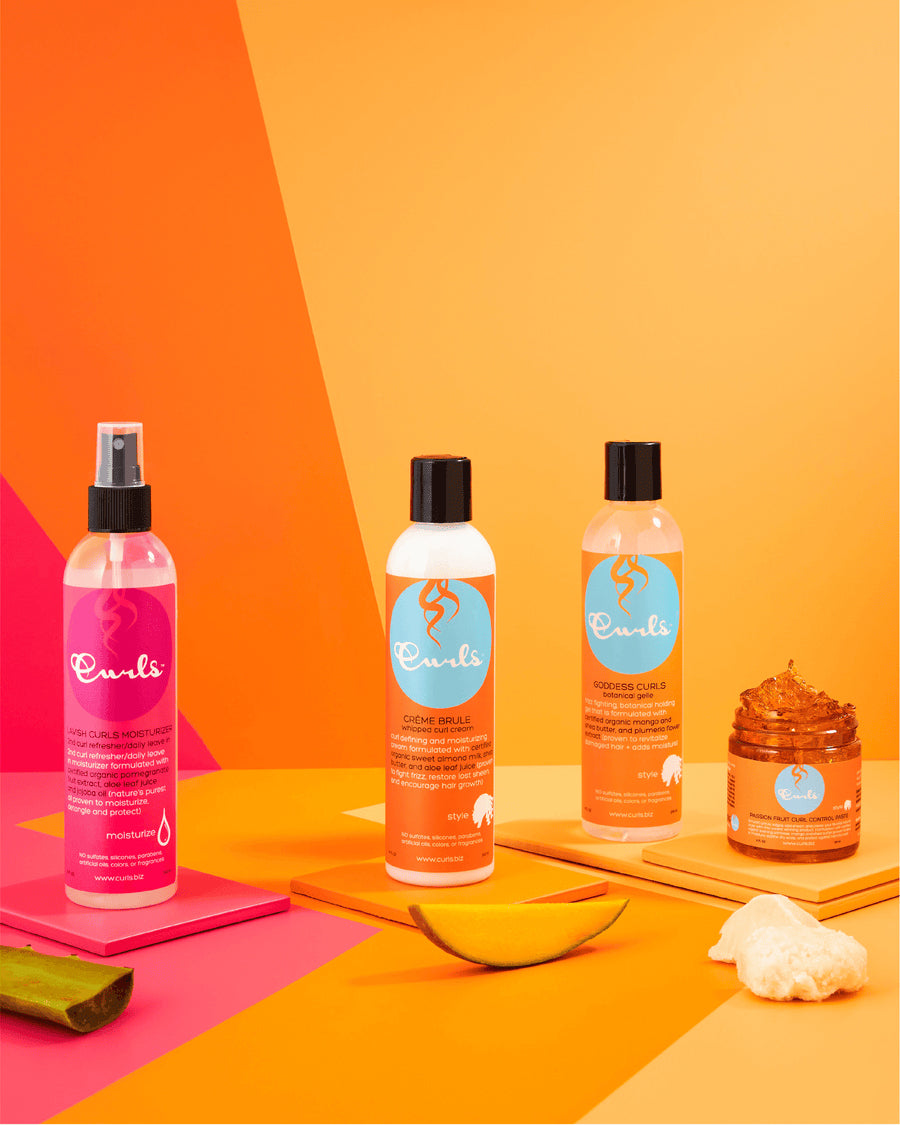 Curls hair care products: Lavish Curls Moisturizer (pink spray), Curl Milk and Curl Gel bottles and a container with styling product. Colorful background.