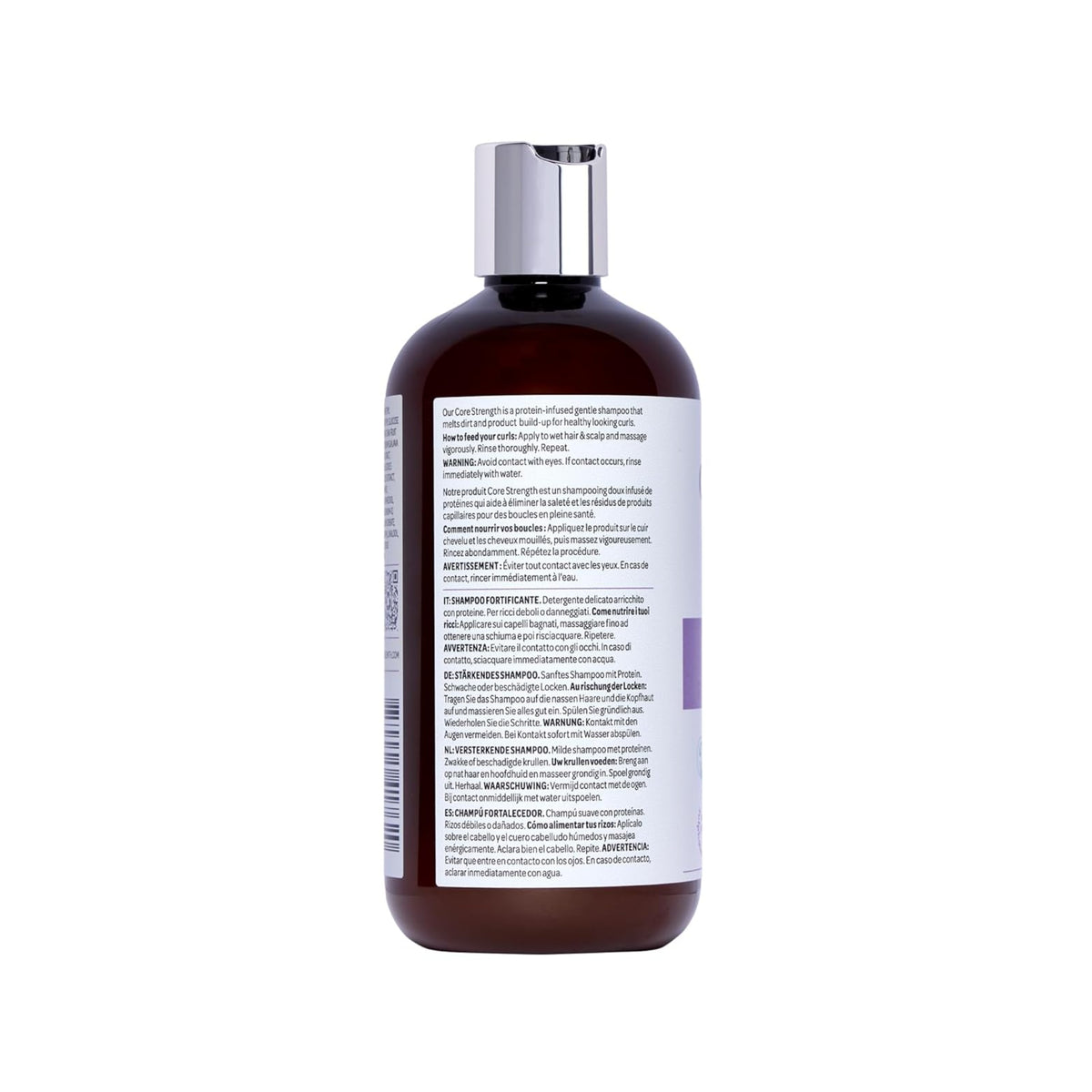 Brown plastic bottle with silver lid of Core Strength shampoo with label in multilingual instructions for use.