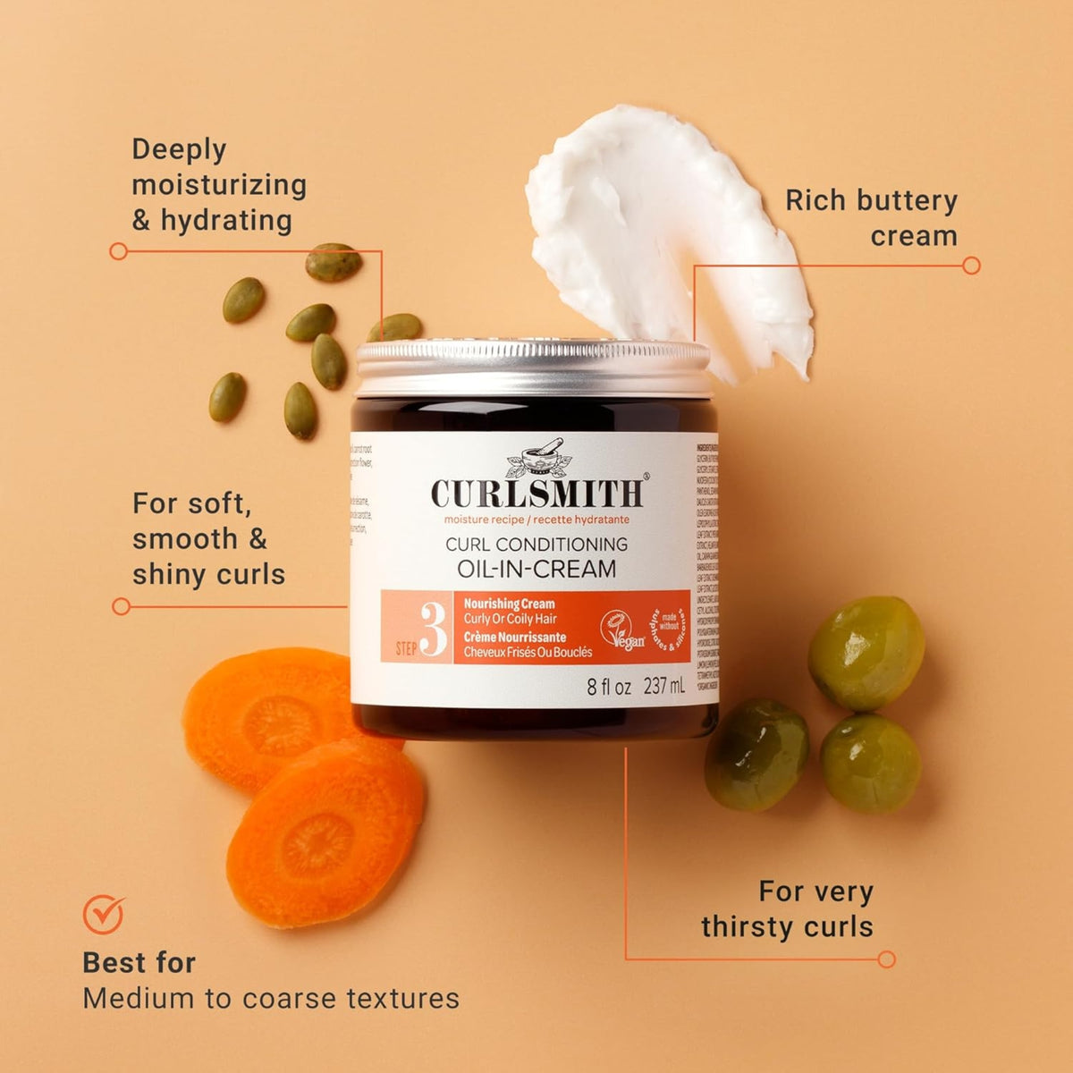 Curlsmith Curl Conditioning Oil-in-Cream in a dark glass jar with a creamy texture, surrounded by carrots, olives and pumpkin seeds.