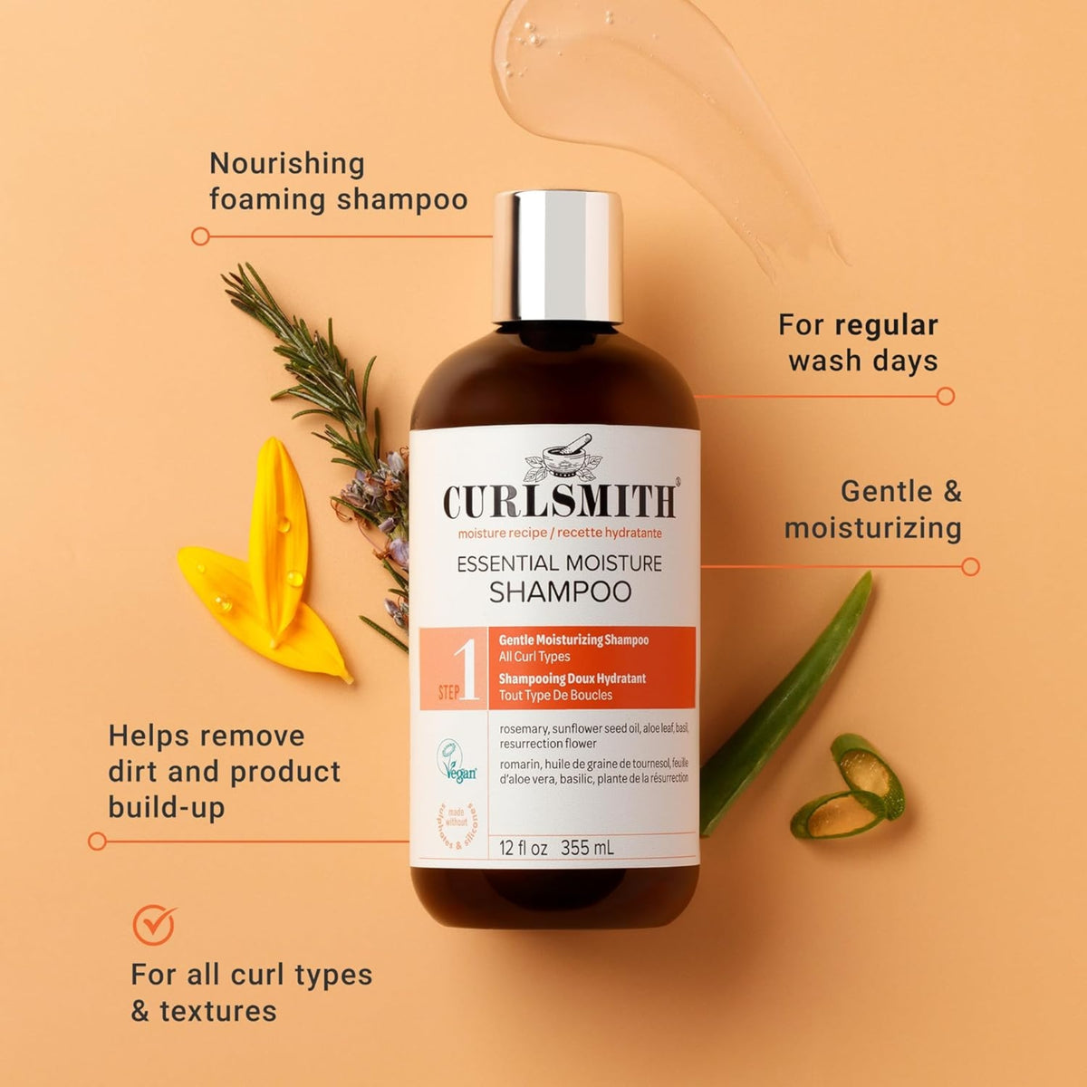 Curlsmith Essential Moisture Shampoo bottle with rosemary, aloe vera and flowers on light orange background.