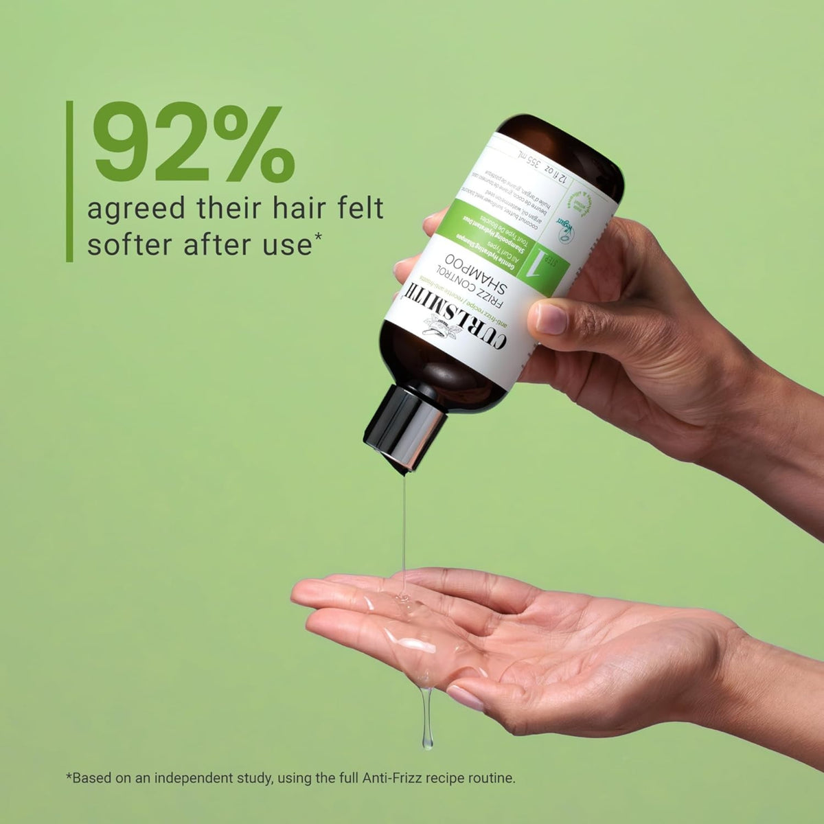 Hand pouring Curlsmith Frizz Control Shampoo into open palm, 92% experienced softer hair.