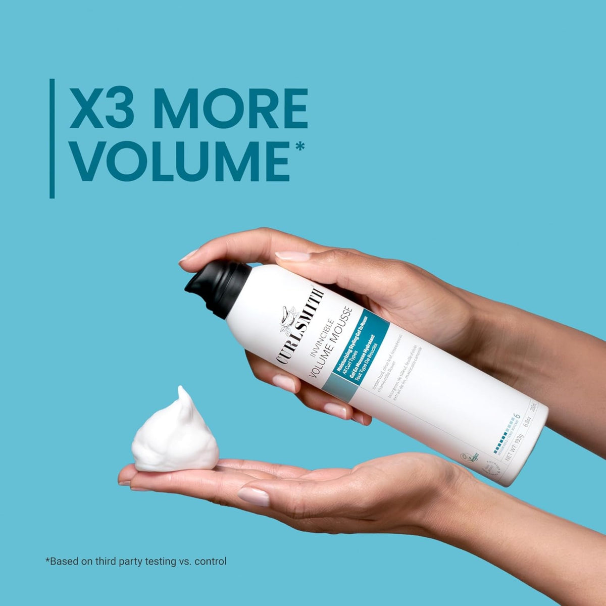 Hand holds Curlsmith Invincible Volume Mousse and squeezes white foam into other hand, text 'X3 More Volume'.