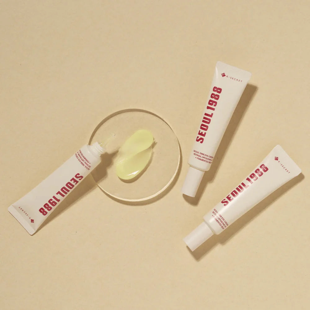 Three tubes of K-Secret Eye Cream: Retinal Liposome 4% + Fermented Bean 30 ml lie on a beige background with the cream shown in the middle.