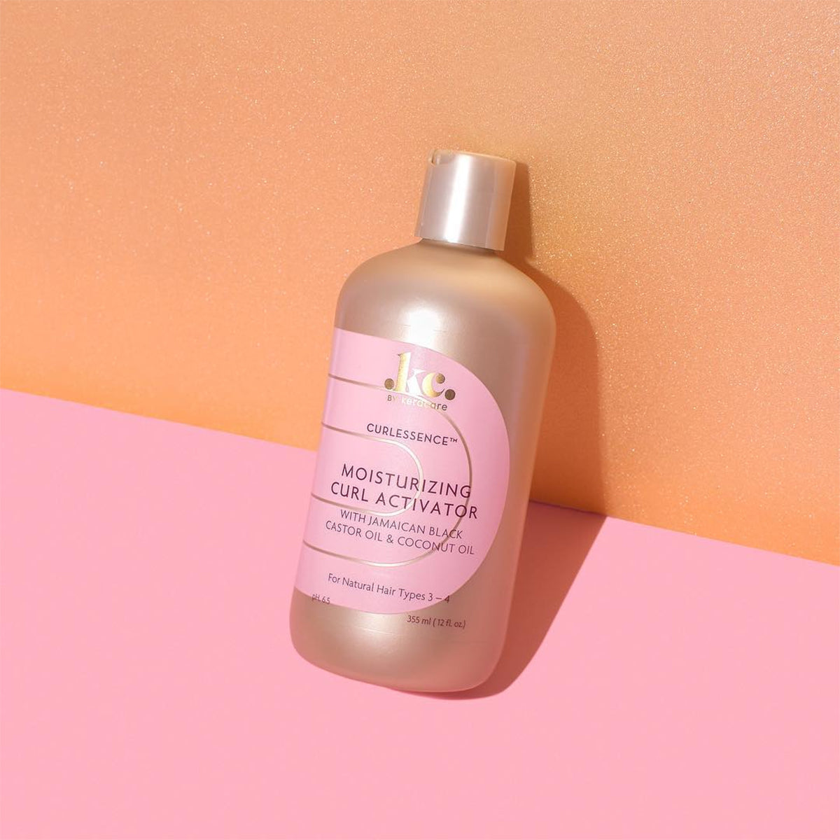 Keracare Curlessence Moisturizing Curl Activator for natural hair types 3-4, 355ml bottle with gold cap, photographed against a colorful background.