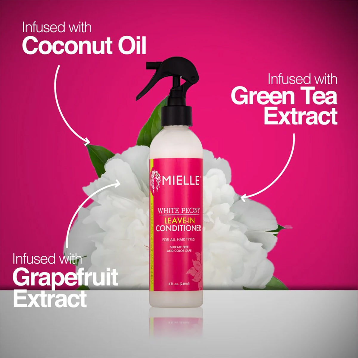 Mielle White Peony Leave-In Conditioner (240 ml) presented in front of a white peony, highlighting the ingredients coconut oil, green tea extract and grapefruit extract.