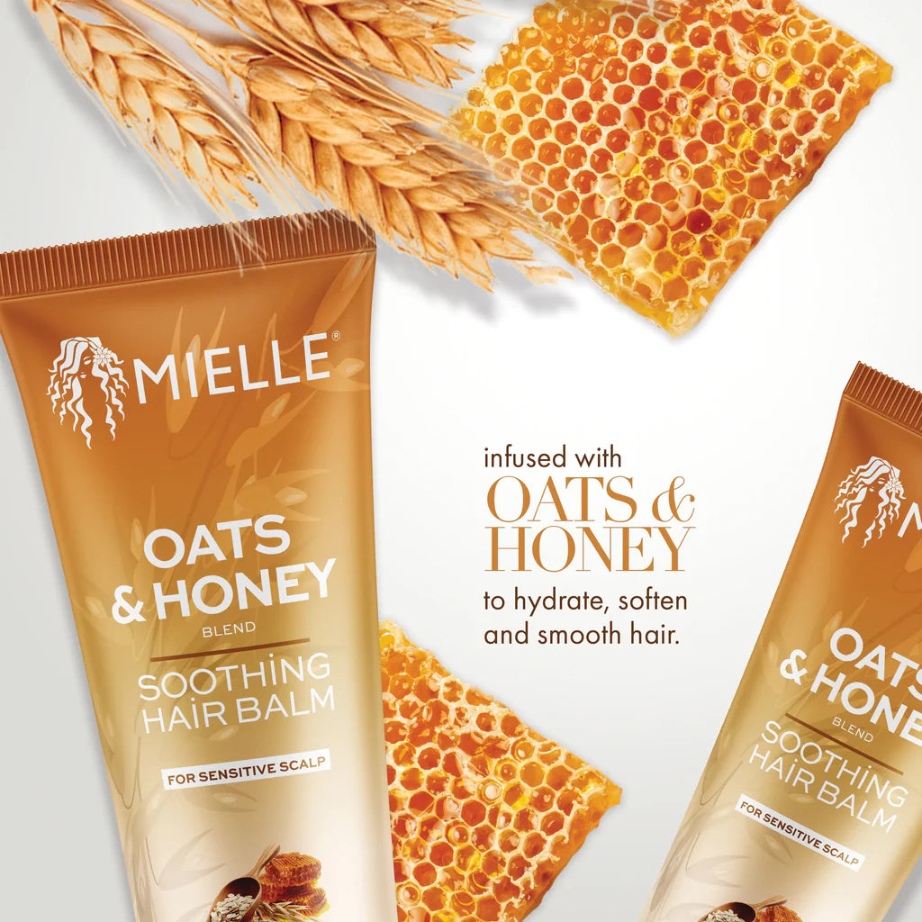 Mielle Oats & Honey Soothing Hair Balm 177ml surrounded by gingerbread and oat straw on a light background.