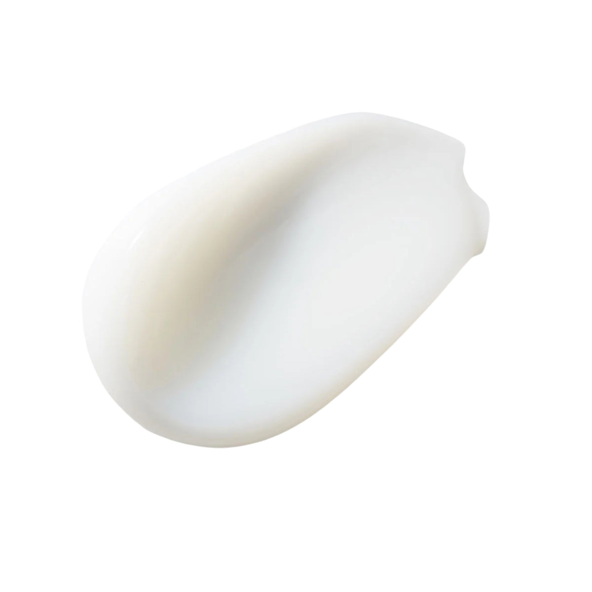 Creamy white face cream smeared in a smooth blob on a white background.