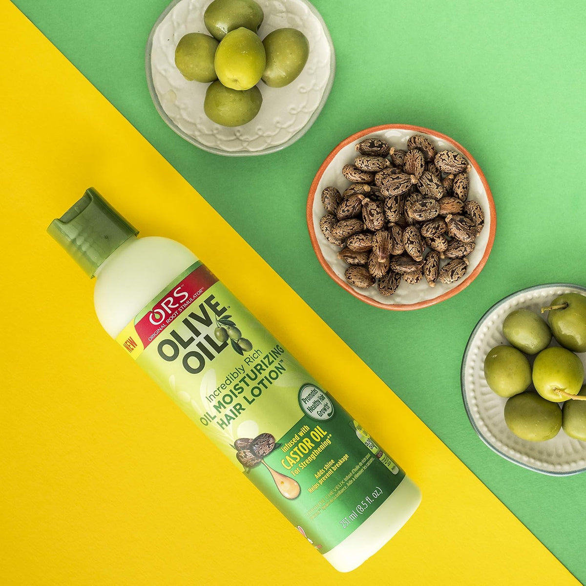 ORS Olive Oil Incredibly Rich Oil Moisturizing Hair Lotion surrounded by olives and castor seeds that illustrate the natural ingredients.