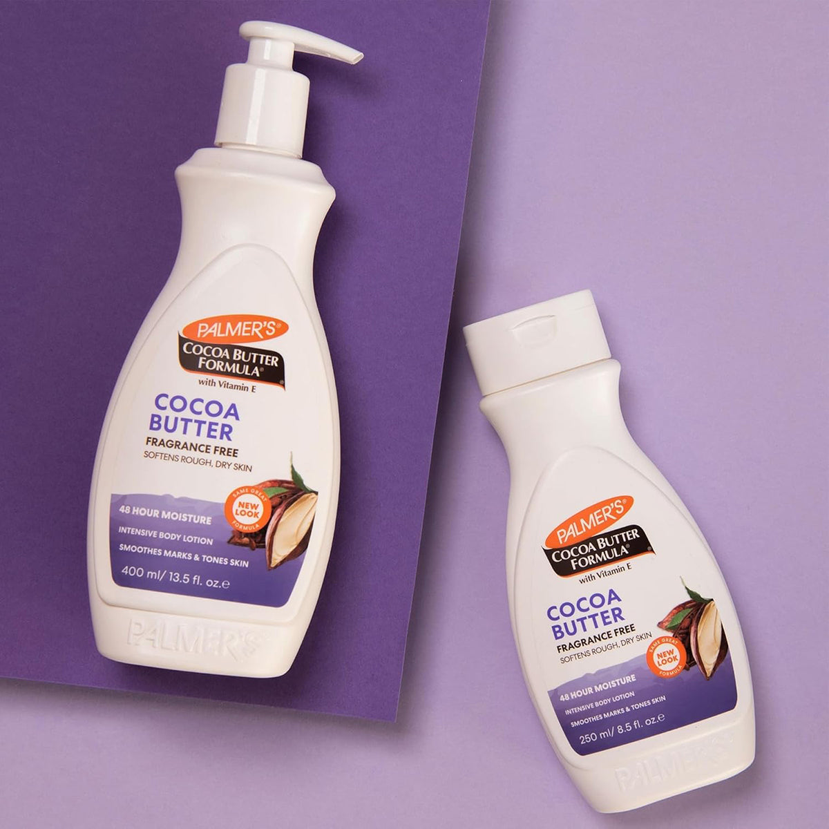 Two bottles of Palmer's Cocoa Butter Formula Fragrance Free Lotion: a large 400ml pump bottle and a smaller 250ml bottle. Both are designed for sensitive skin.