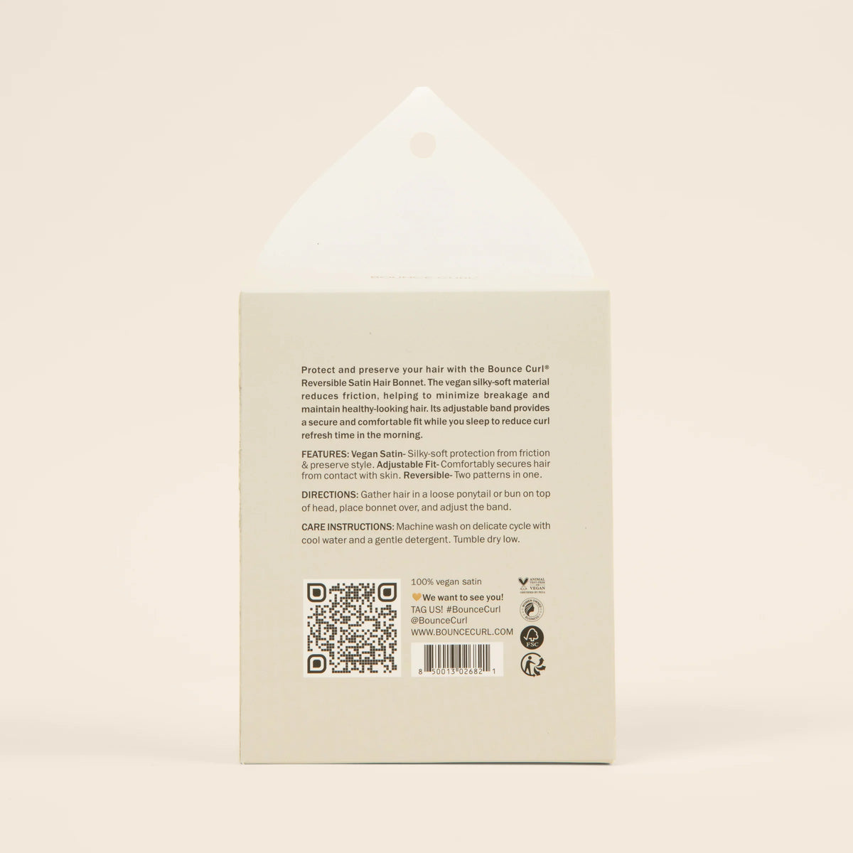 Text on light gray packaging of Bounce Curl Reversible Satin Hair Bonnet with product info and care instructions in black writing.