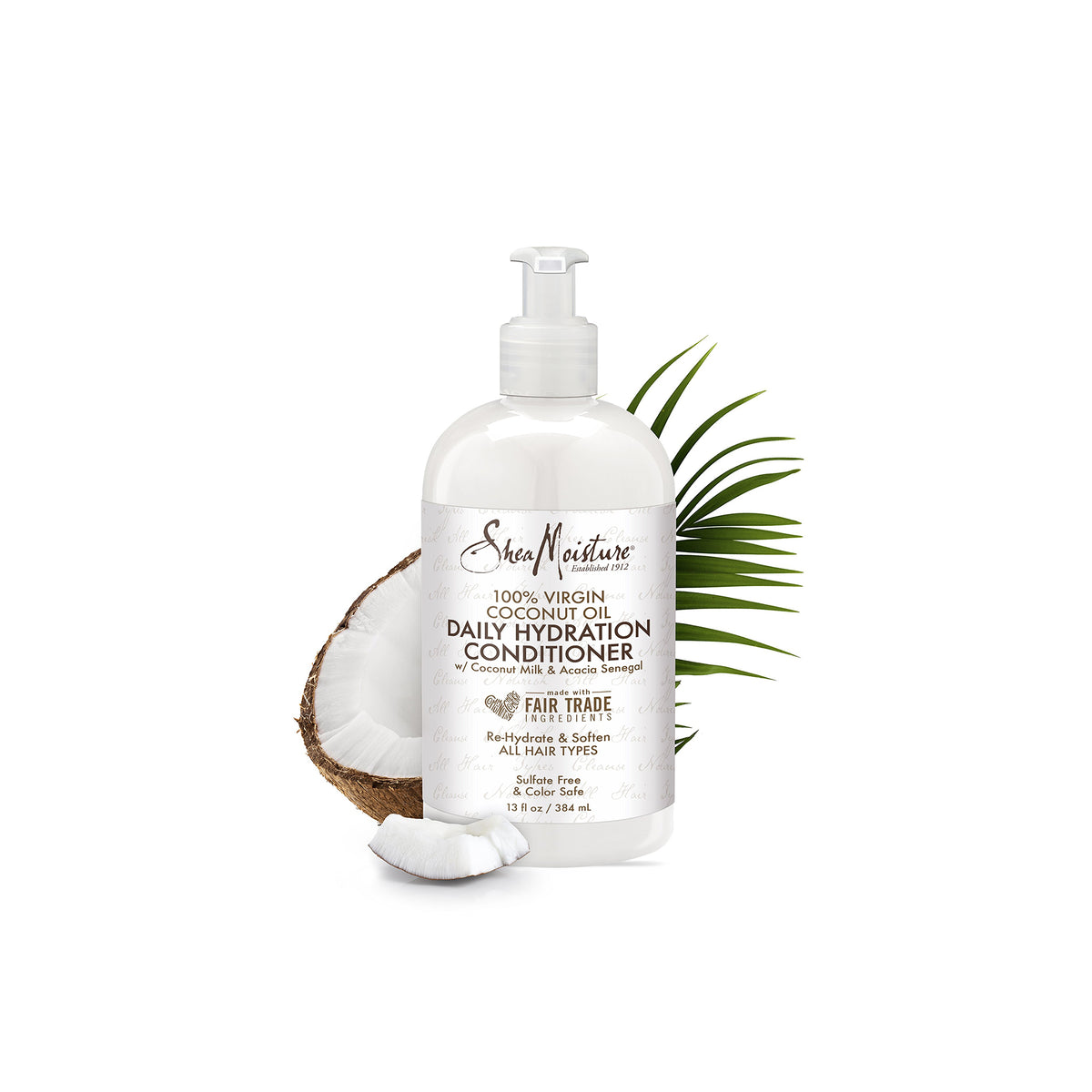 A white pump bottle of Shea Moisture 100% Virgin Coconut Oil Daily Hydration Conditioner, 384ml. The bottle stands in front of a white background with a coconut in the foreground.