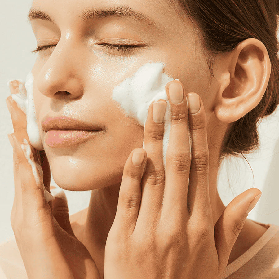 Gentle facial cleanser with SKIN1004 Madagascar Centella Ampoule Foam 125ml is foamed onto damp skin with eyes closed.