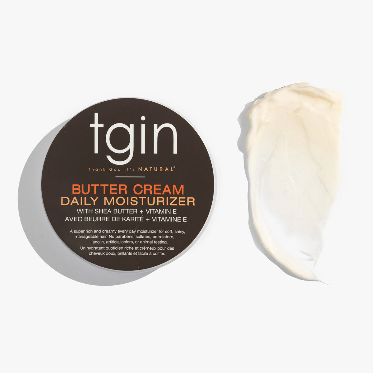 TGIN Butter Cream Daily Moisturizer 340gr with shea butter and vitamin E next to creamy, white moisturizer.